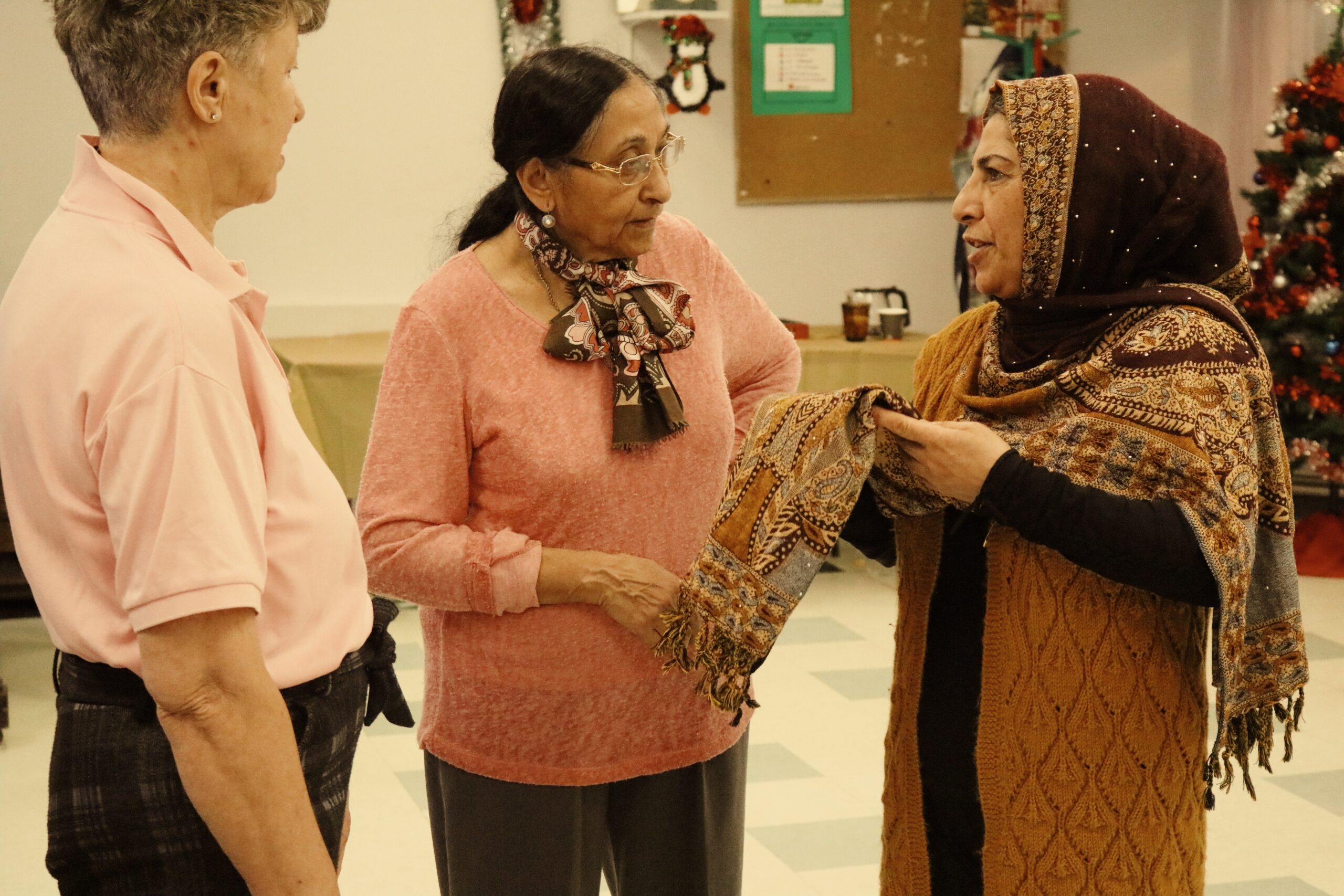 Three women talking to each other. 