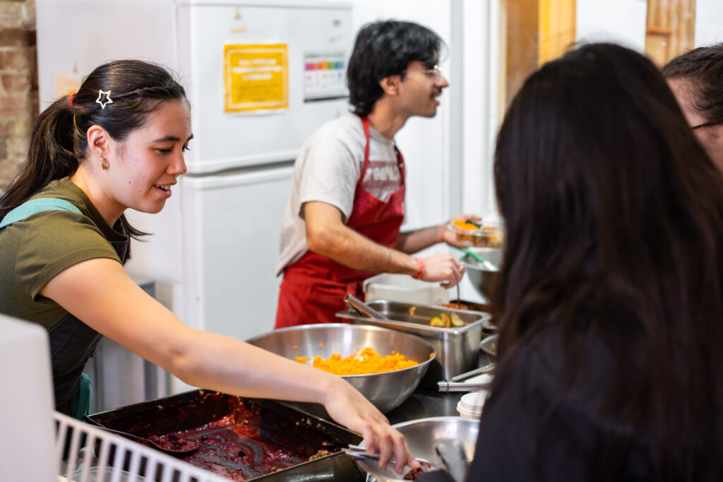 Two volunteers serve food